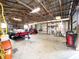 Large garage with high ceilings, trailer, lawnmower, and various tools and equipment at 812 Jameson Rd, Lithia, FL 33547