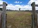Open horse ring or training area with wooden fencing and a grass surface for equestrian activities at 812 Jameson Rd, Lithia, FL 33547