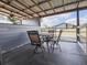Outdoor dining area with a metal table and chairs under a covered patio with a view of the property at 812 Jameson Rd, Lithia, FL 33547