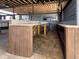 Wide angle view of outdoor kitchen and bar area featuring wood and granite with a sink and stainless appliances at 812 Jameson Rd, Lithia, FL 33547