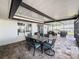 A covered outdoor patio featuring a dining area with seating for six at 812 Jameson Rd, Lithia, FL 33547