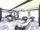 A covered outdoor patio featuring a seating area with wicker furniture at 812 Jameson Rd, Lithia, FL 33547