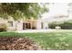 View of the back yard featuring a covered patio, lush lawn, and some garden beds at 8338 Old Town Dr, Tampa, FL 33647