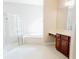 Bright bathroom boasts a soaking tub, a walk-in shower, and wood cabinetry offering ample storage at 8338 Old Town Dr, Tampa, FL 33647