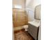 Well-lit bathroom featuring a tiled walk-in shower and stylish vanity with a white countertop at 8338 Old Town Dr, Tampa, FL 33647