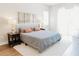 Bright bedroom features a comfortable bed, wood floors, and neutral decor, creating a relaxing atmosphere at 8338 Old Town Dr, Tampa, FL 33647