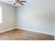 Unfurnished bedroom features wood flooring, neutral walls, and a ceiling fan at 8338 Old Town Dr, Tampa, FL 33647