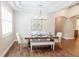 Formal dining area with tray ceiling, decorative chandelier, and an adjacent sitting room at 8338 Old Town Dr, Tampa, FL 33647