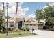 Charming single-Gathering home with a well-manicured lawn and a three-car garage on a sunny day at 8338 Old Town Dr, Tampa, FL 33647