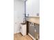 This is a great laundry room setup with cabinets, a sink, and wood floors at 8338 Old Town Dr, Tampa, FL 33647