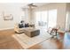 Cozy living room with hardwood floors, rocking chair, and sliding glass doors to the lanai at 8338 Old Town Dr, Tampa, FL 33647