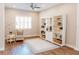 Bright living room with hardwood floors, ceiling fan, built-in shelving, and large windows at 8338 Old Town Dr, Tampa, FL 33647