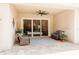 Covered patio with brick flooring, ceiling fan and sliding glass doors to the backyard at 8338 Old Town Dr, Tampa, FL 33647