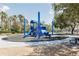 Community playground with blue play structure, slides, and picnic area under mature trees at 8338 Old Town Dr, Tampa, FL 33647