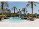 Luxurious community pool surrounded by tropical landscaping with lounge chairs and cabanas at 8338 Old Town Dr, Tampa, FL 33647