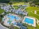 Aerial view of a community pool area with pool, waterslide and ample parking at 8717 Emeraldwood Way, Land O Lakes, FL 34637