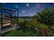 Screened-in porch overlooking a beautifully landscaped backyard and pond, perfect for outdoor enjoyment at 8717 Emeraldwood Way, Land O Lakes, FL 34637