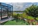 Picturesque backyard with a pond view, lush landscaping, and a screened lanai for enjoying the outdoors at 8717 Emeraldwood Way, Land O Lakes, FL 34637