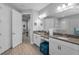 Bathroom features double vanities with granite countertops, a makeup vanity, and wood plank flooring at 8717 Emeraldwood Way, Land O Lakes, FL 34637