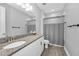 Well-lit bathroom featuring granite countertop, white cabinetry, and modern fixtures at 8717 Emeraldwood Way, Land O Lakes, FL 34637