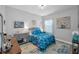Comfortable bedroom with blue accents, a large window, and modern decor at 8717 Emeraldwood Way, Land O Lakes, FL 34637