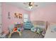 Cozy pink-walled room with ample natural light and playful decor at 8717 Emeraldwood Way, Land O Lakes, FL 34637