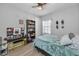 Bright bedroom with wood floors, a window, and an eclectic decor at 8717 Emeraldwood Way, Land O Lakes, FL 34637