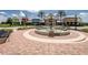 Exterior of community center featuring a charming fountain, landscaping, and seating at 8717 Emeraldwood Way, Land O Lakes, FL 34637