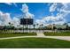 Community pool area featuring an adjacent pool house, palm trees and numerous lounge chairs at 8717 Emeraldwood Way, Land O Lakes, FL 34637