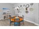 Cozy dining area with decoratively adorned wall clocks at 8717 Emeraldwood Way, Land O Lakes, FL 34637