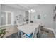 Bright dining room with white table and chairs and decorative chandelier at 8717 Emeraldwood Way, Land O Lakes, FL 34637