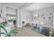 Open-concept dining room with a modern table, stylish decor, and plenty of natural light at 8717 Emeraldwood Way, Land O Lakes, FL 34637
