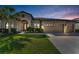 Inviting exterior view of home with a well-maintained lawn and attractive landscaping details at 8717 Emeraldwood Way, Land O Lakes, FL 34637