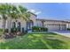 Charming home featuring a well-manicured lawn, lush landscaping, and a spacious two-car garage at 8717 Emeraldwood Way, Land O Lakes, FL 34637