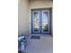 Inviting front door with decorative glass, paired with a cheerful welcome mat and floral arrangement at 8717 Emeraldwood Way, Land O Lakes, FL 34637