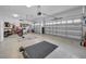 Spacious, two-car garage with ample storage space and a clean epoxy floor at 8717 Emeraldwood Way, Land O Lakes, FL 34637