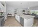 Open kitchen features a large island with a sink, blending seamlessly with the living space and patio at 8717 Emeraldwood Way, Land O Lakes, FL 34637