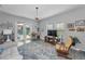 Living room features a door to the pool, a ceiling fan, and a rocker at 8717 Emeraldwood Way, Land O Lakes, FL 34637