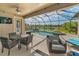 Relaxing screened patio with dining and lounge seating overlooking the beautiful pool and tranquil water views beyond at 8717 Emeraldwood Way, Land O Lakes, FL 34637