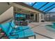 Expansive screened patio with comfortable seating, ceiling fans, and a view of the pool and scenic backyard at 8717 Emeraldwood Way, Land O Lakes, FL 34637