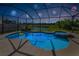 Inviting screened pool and spa with a tranquil water view, enhanced by festive fireworks illuminating the night sky at 8717 Emeraldwood Way, Land O Lakes, FL 34637