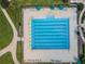 Overhead view of a community lap pool with multiple lanes, surrounded by lounge chairs and landscaped areas at 8717 Emeraldwood Way, Land O Lakes, FL 34637