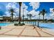 Resort-style pool featuring palm trees, lounge chairs and an adjacent building for refreshments at 8717 Emeraldwood Way, Land O Lakes, FL 34637