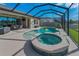 Inviting screened pool and spa with a sunny deck and outdoor seating area, perfect for relaxing and entertaining at 8717 Emeraldwood Way, Land O Lakes, FL 34637