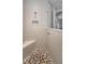 Walk-in shower boasts pebble floor, built in bench and alcove, and a chrome shower head at 8717 Emeraldwood Way, Land O Lakes, FL 34637