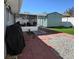 Backyard featuring stone and brick elements, a shed, and a partially enclosed porch at 8728 Mcadam Pl, Tampa, FL 33634