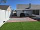 Backyard with small patch of grass, stone elements, and brick enclosed by a fence at 8728 Mcadam Pl, Tampa, FL 33634
