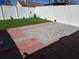 Backyard features a small patch of grass, stone, and brick elements enclosed by a fence at 8728 Mcadam Pl, Tampa, FL 33634