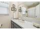 Bathroom featuring a gray vanity with shell decor and a white countertop at 8728 Mcadam Pl, Tampa, FL 33634