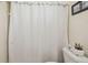 Bathroom featuring a toilet and white shower curtain at 8728 Mcadam Pl, Tampa, FL 33634
